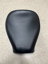 Black Seat for Baja Mini Bike MB165 & MB200 (Baja Heat, Mini Baja, Baja Warrior) (Blemished) on a tile floor, showcasing close-up details of its leather surface.