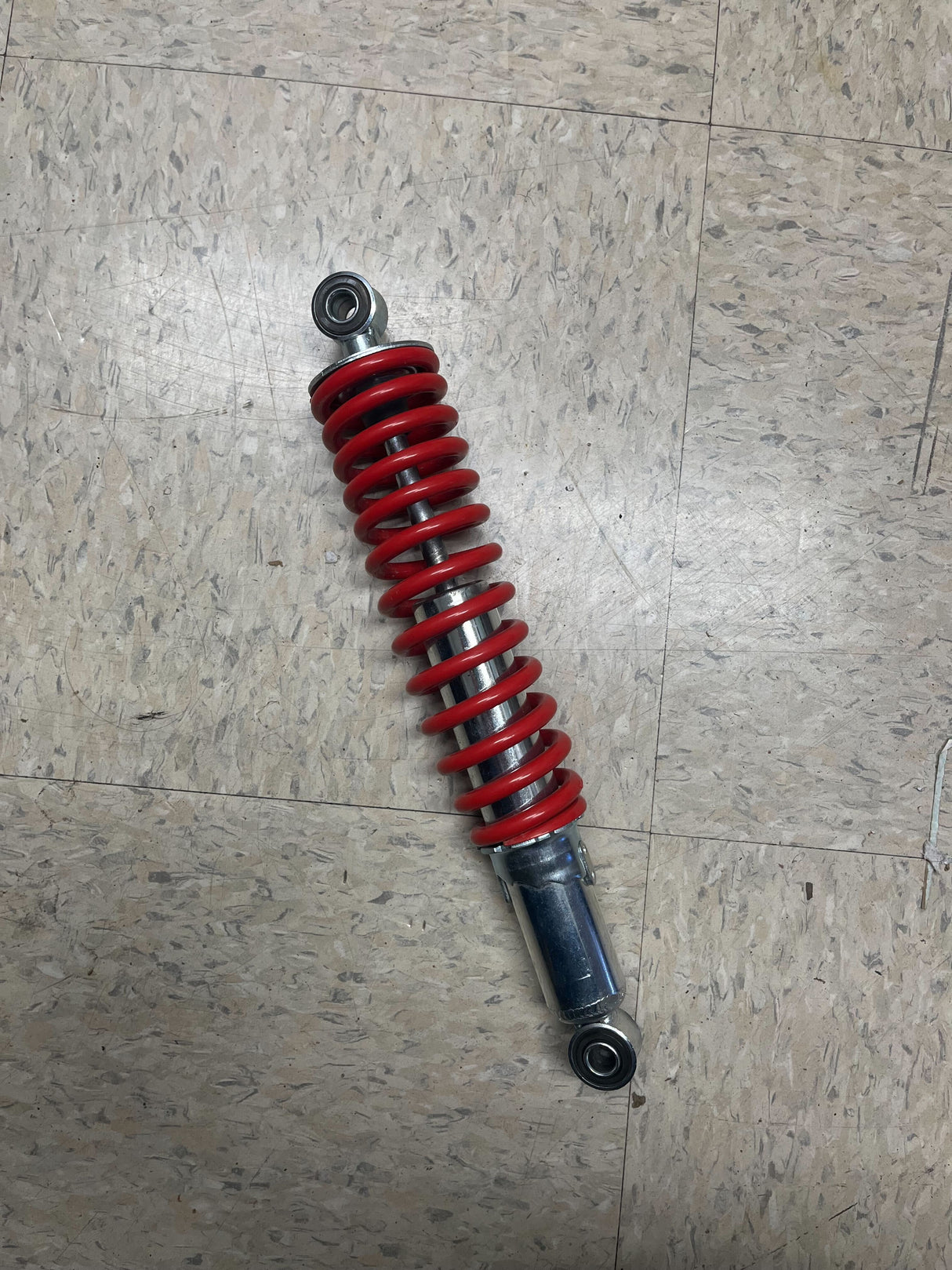 12 Adjustable Shock for Go-Karts & Mini Bikes (10 mm (3/8) ID Red) (Single), featuring a red coil spring with a silver shock absorber, ideal for enhancing ride comfort and safety.