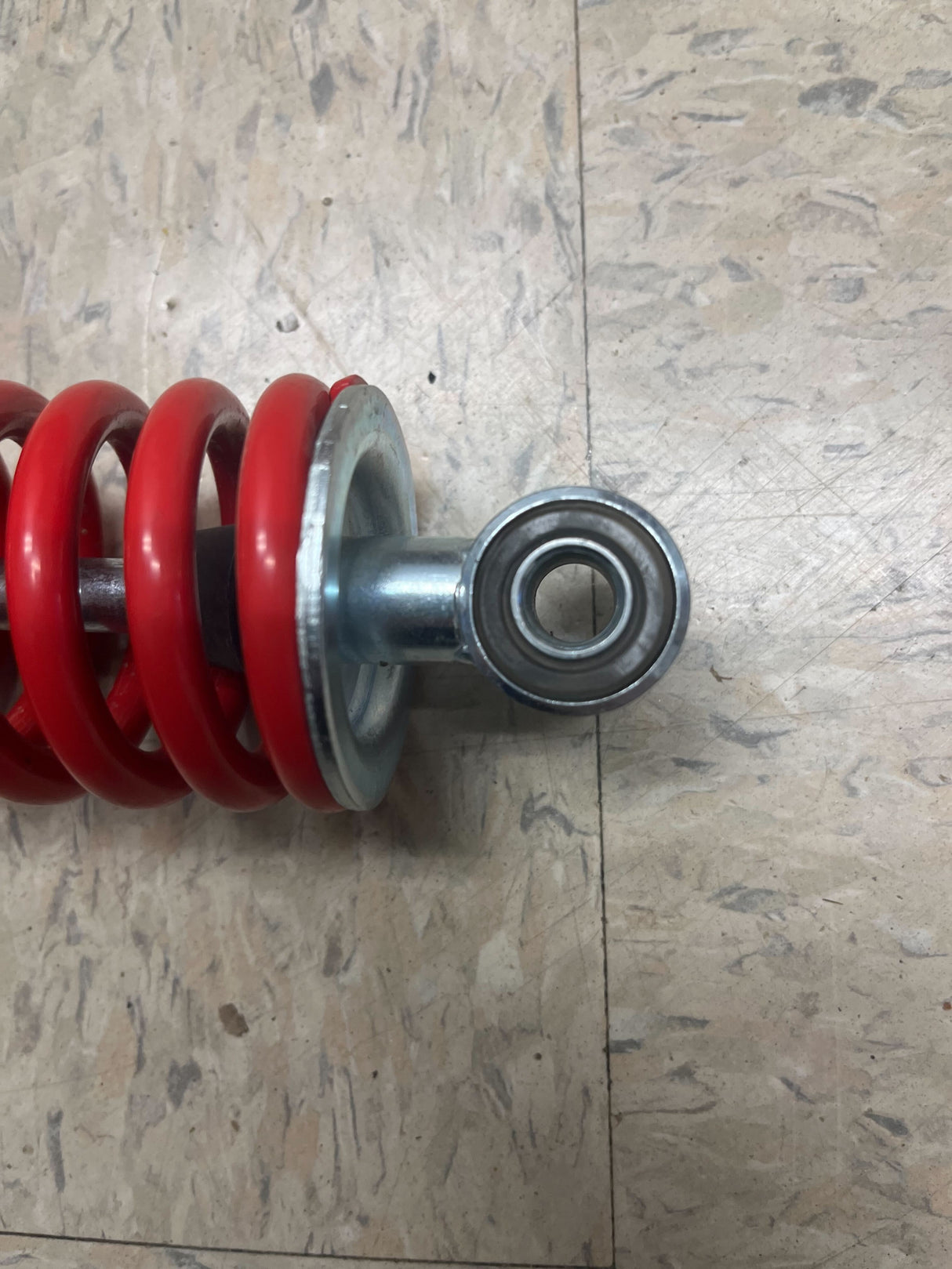 12 Adjustable Shock for Go-Karts & Mini Bikes (10 mm (3/8) ID Red) (Single) shown as a red coil spring on a white surface, highlighting its durable construction and sleek design.