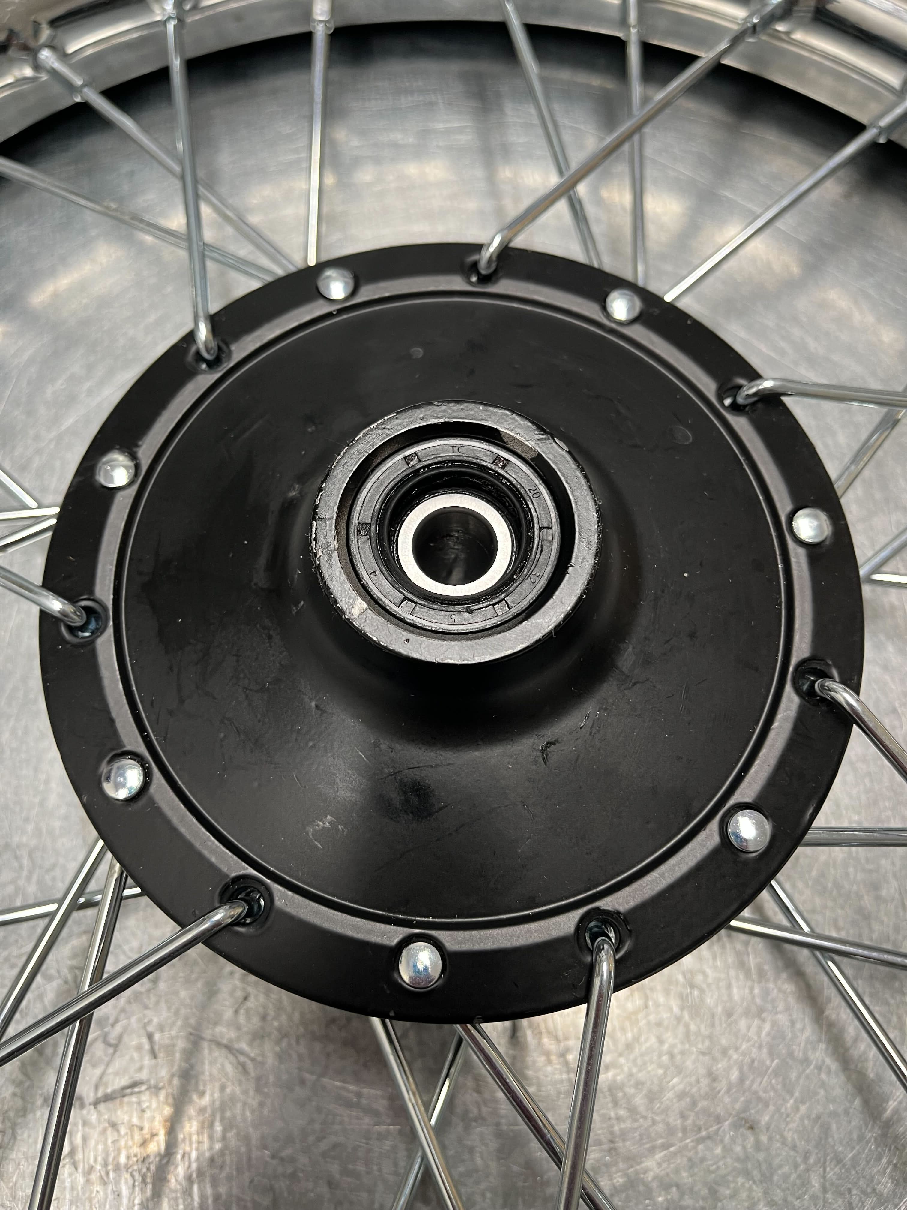 14 (2.50-14) Front Wheel Assembly for Dirt Bikes (Blemished) featuring a black rim, metal spokes, and a knobby tire with wheel bearings, suitable for various 50cc dirt bike models.
