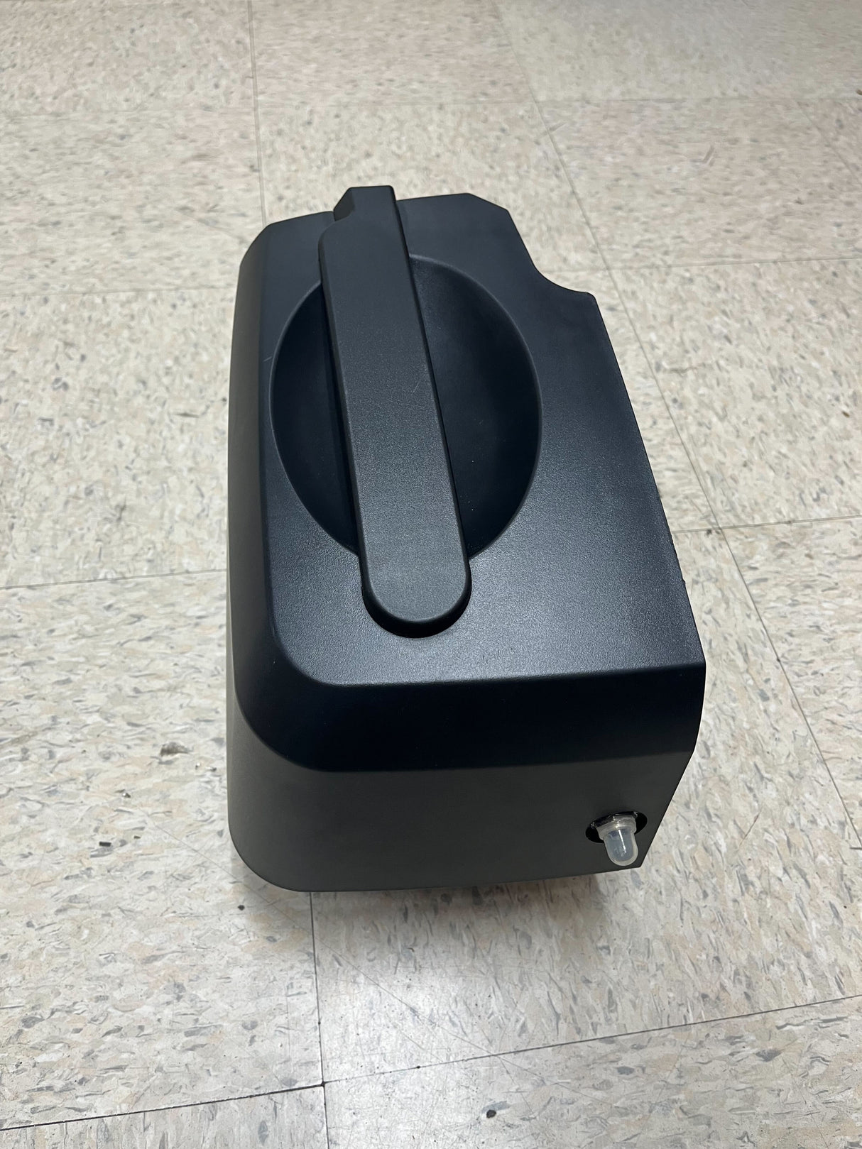 Right Battery Box Assembly for Golden Buzzaround EX & LX Scooters, shown as a black box with a handle on a tile floor, essential for lightweight travel scooter disassembly.