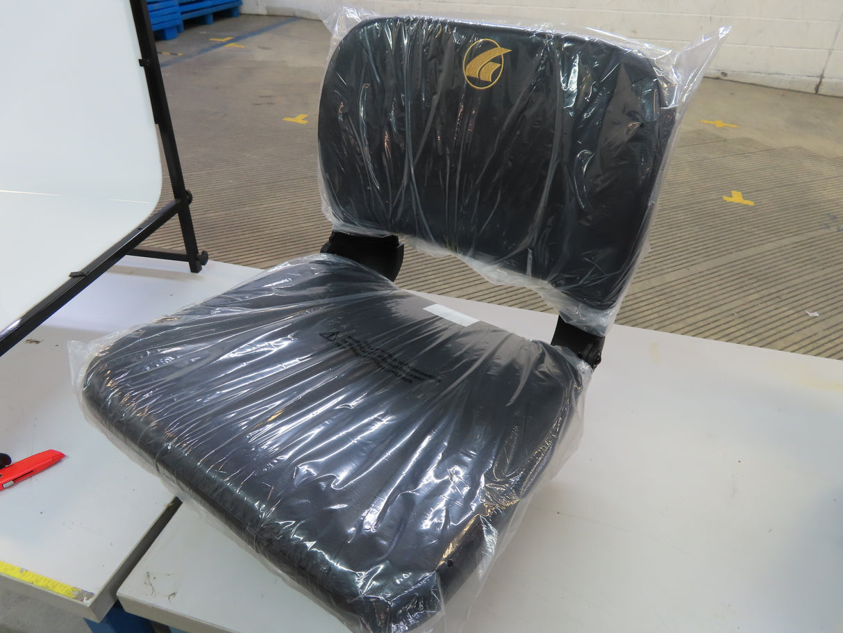 20x18 Black Stadium Seat with Slide Swivel for the Golden Buzzaround XL (GB117/GB147) wrapped in plastic, placed on a white table with black metal legs.