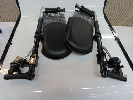 Elevating Leg Rests with Calf Pad for Jazzy and Jet Power Chairs (Set of 2) (Blemished) showing black leather cushions and adjustable hardware on a white surface.