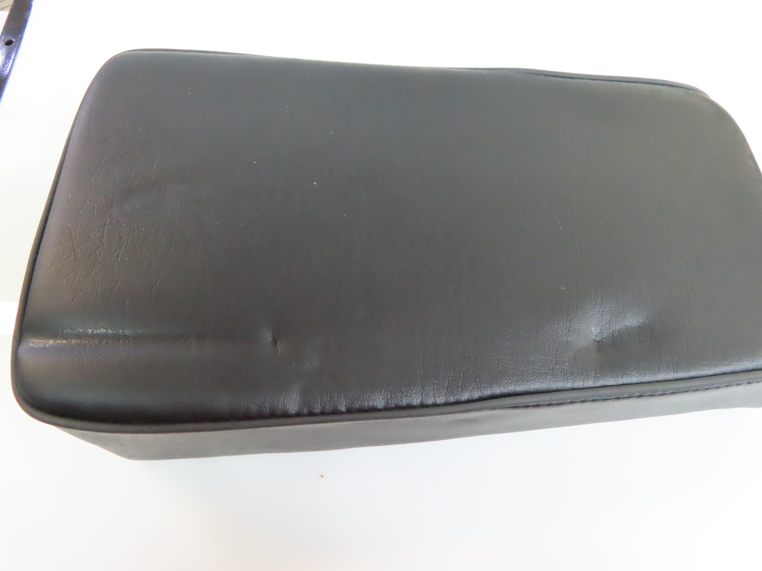 Black leather seat for Coleman CT100U Mini Bike, shown on a white background, offering a smoother, more comfortable ride. Ideal replacement for a worn-out saddle.