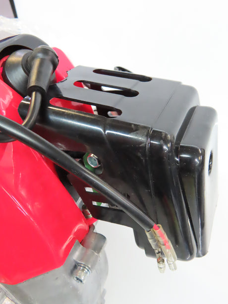 Close-up of a 49cc/52cc Scooter Engine with Electric Start (Blemished), showcasing its intricate components including the black cable, lens, red metal surface, and attached gear reduction transmission.