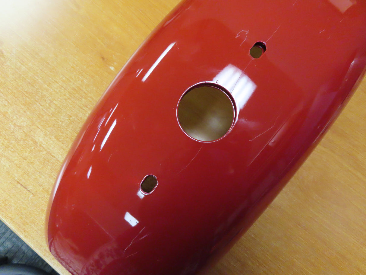 Fender for the Coleman CT200U Trail (Blemished): Close-up of a red fender with multiple holes, designed for front or rear placement on the mini bike.