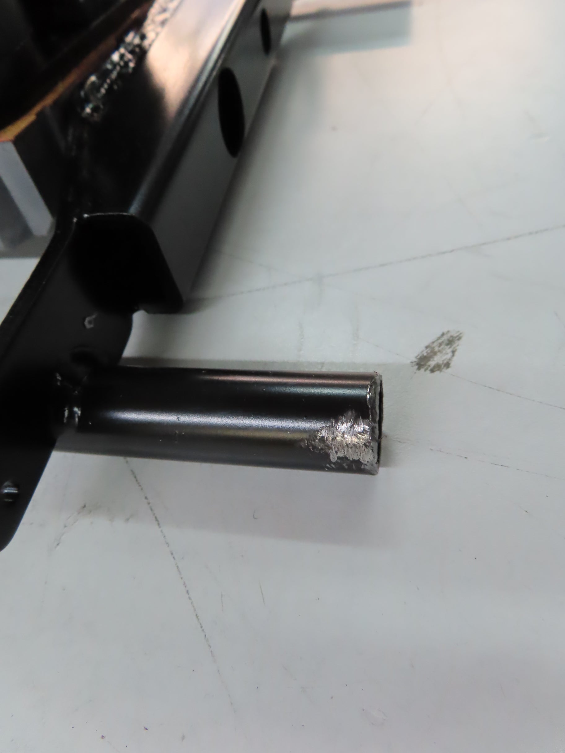 Elevator Seat Motor for the Jazzy Select 6 Ultra (Blemished) shown as a metal pipe with attachment points, placed on a white surface.