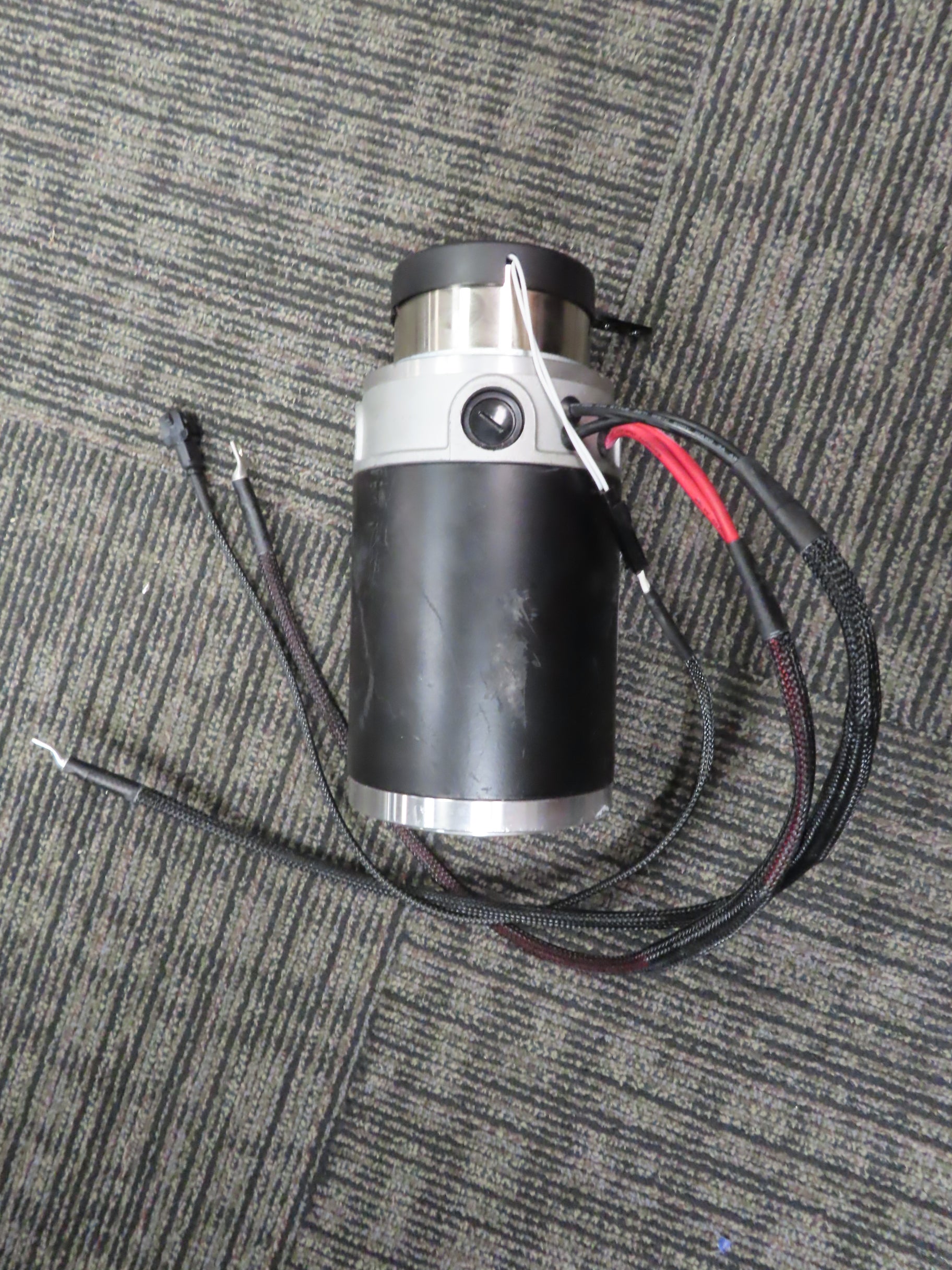 Motor and Brake Assembly for the Pride Pursuit XL (SC714) (Blemished), featuring a cylindrical black and silver device with attached wires.