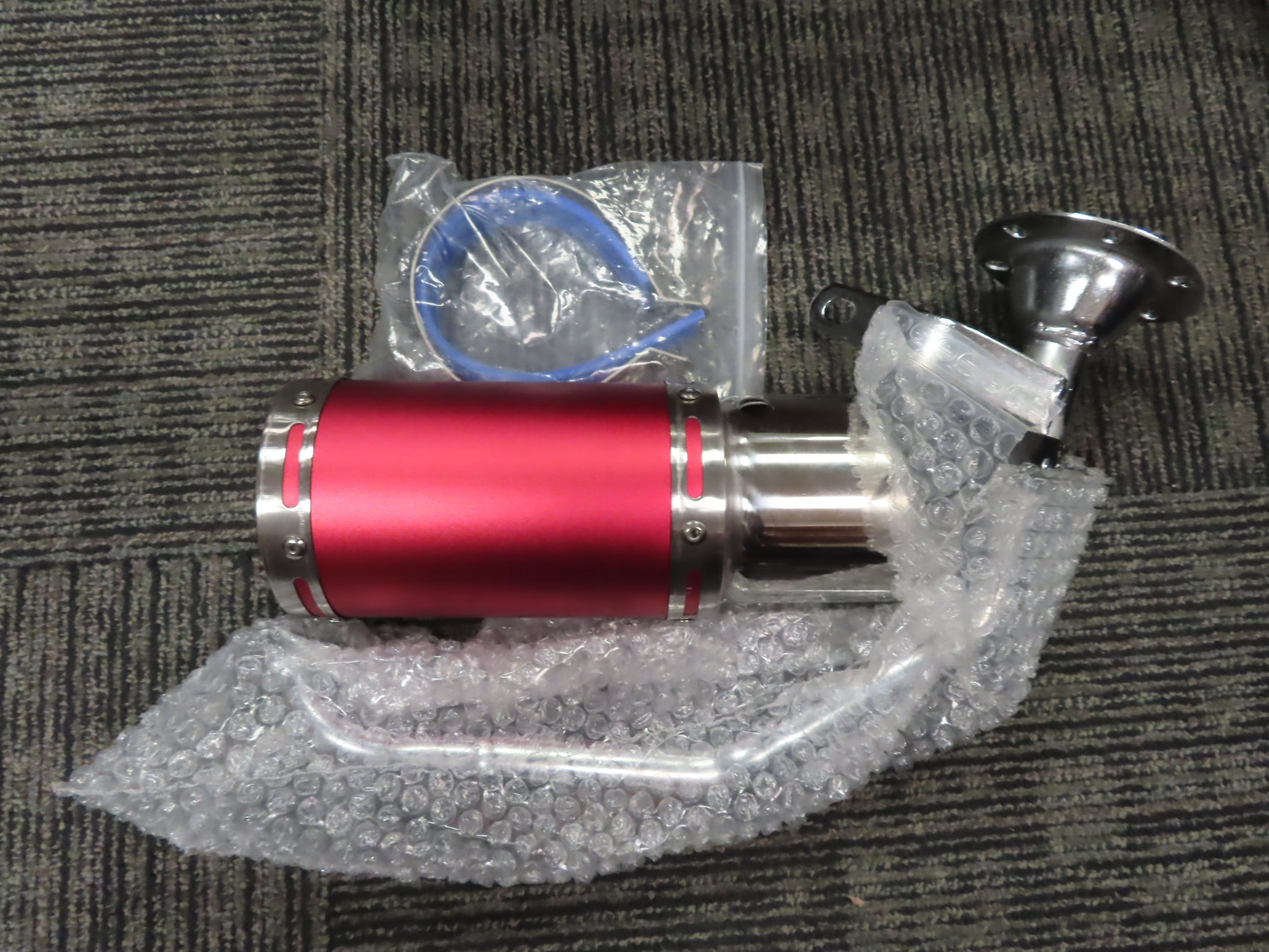 Short Performance Exhaust System for GY6 150cc Scooters & Go-Karts shown with a muffler, exhaust pipe, and bubble wrap packaging.