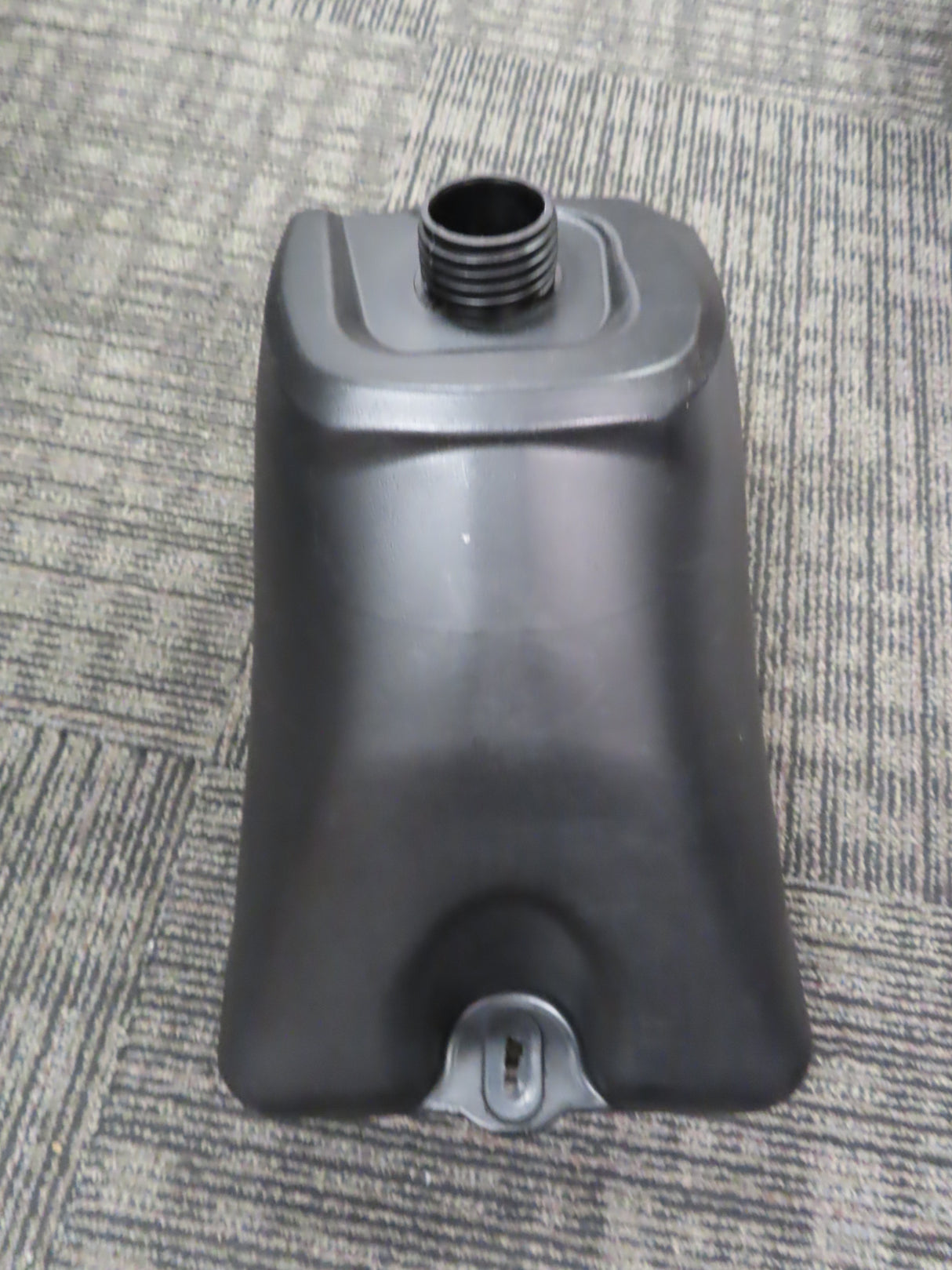 Black Plastic Fuel Tank with Petcock Valve for 90cc to 150cc ATVs, shown on a carpet, featuring a keyhole detail and sleek design, ideal for dirt bikes and small engines.