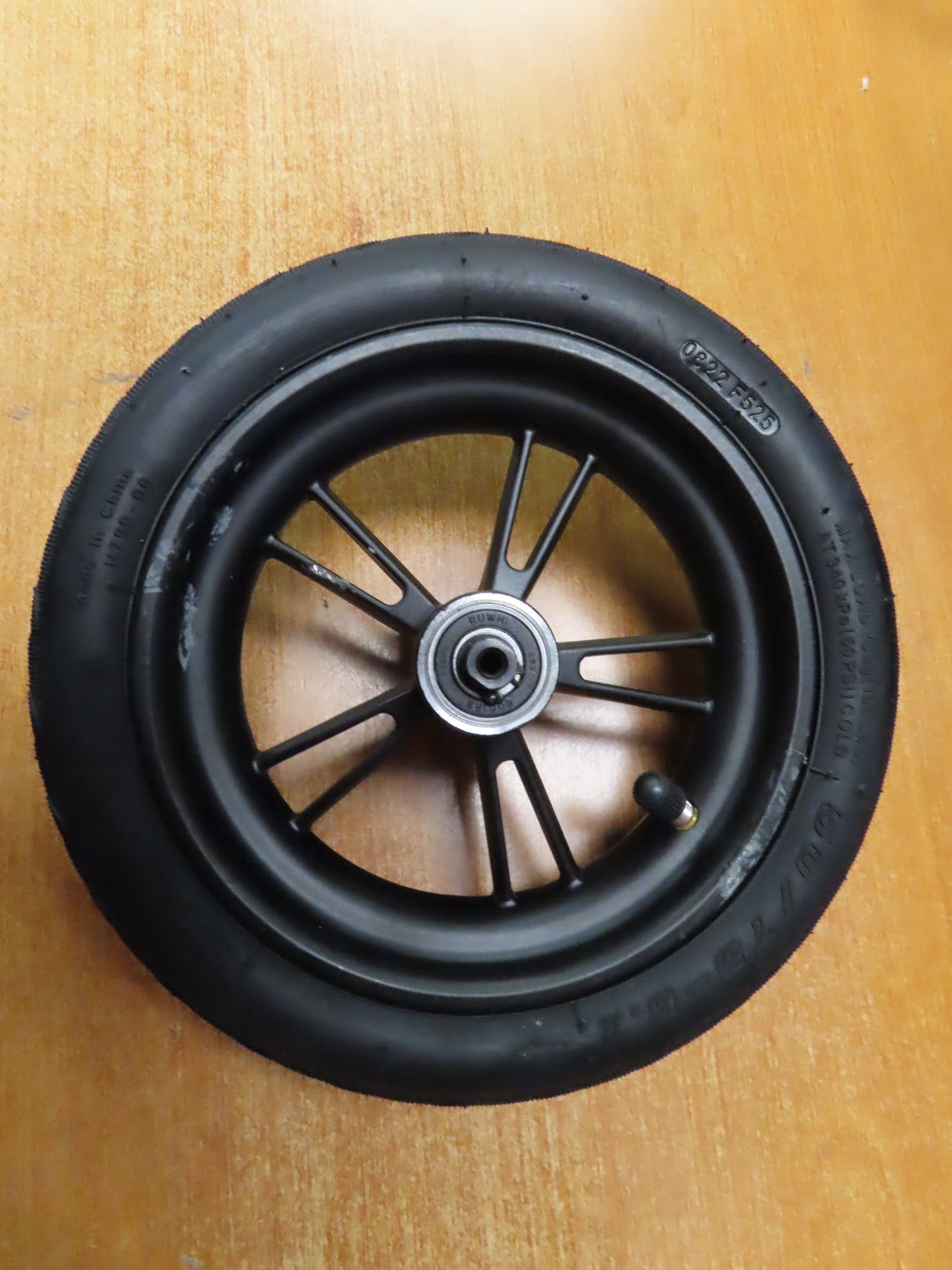 Rear Wheel Assembly for GOTRAX GXL V2 & XR Ultra Electric Scooters (Blemished), featuring a 5-spoke rim, pre-installed bearings, and a mounted tire with visible tread on a wooden surface.