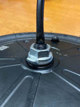 250 Watt Hub Motor & Front Wheel Assembly for GOTRAX GXL V2 & XR Elite Electric Scooters (Blemished), showing a close-up of the hub motor, black container, and attached metal nut and bolt.