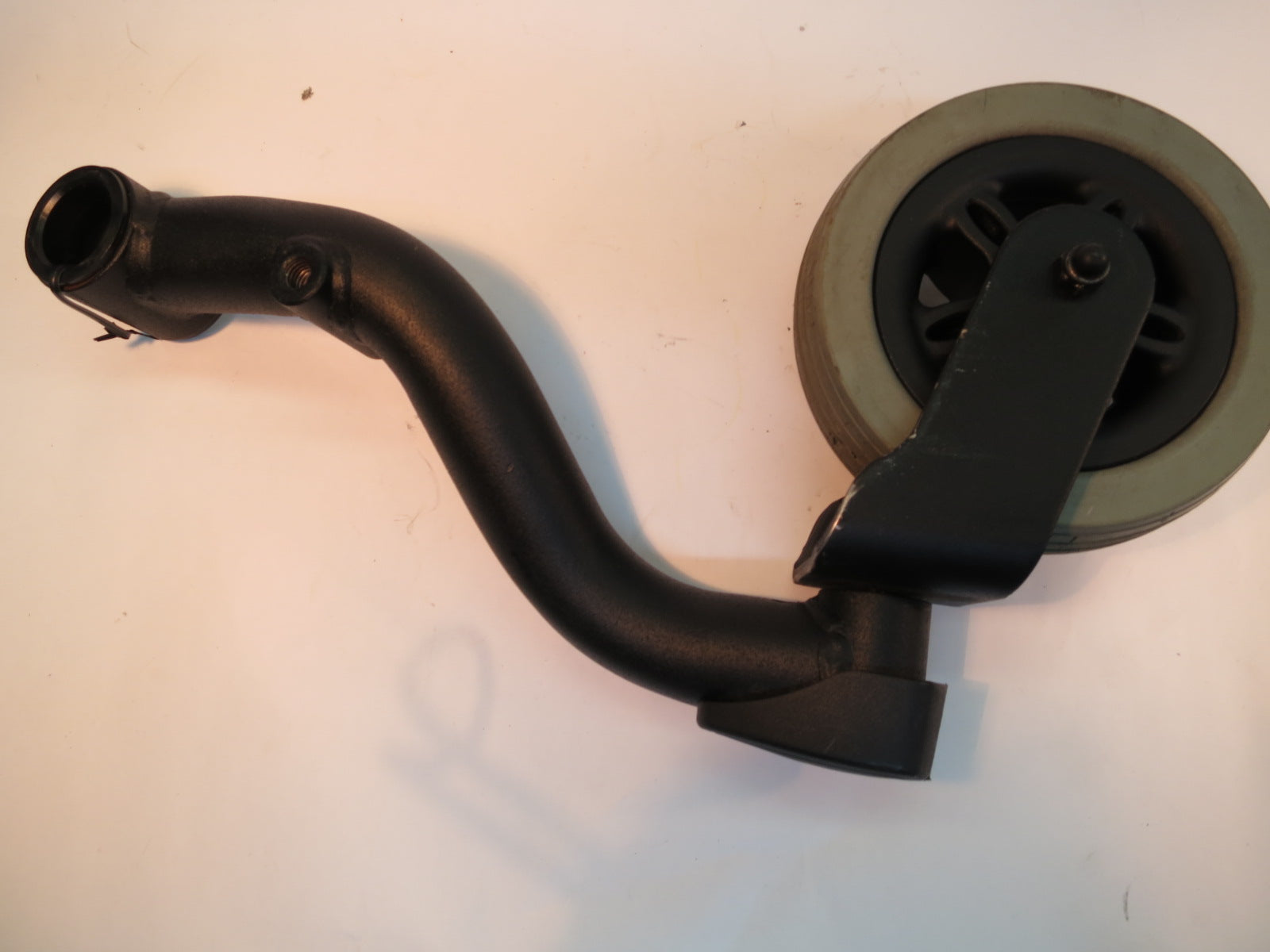 Left Rear Caster and Barrel Assembly for the Jazzy 614 and 614 HD (Used), featuring a black metal wheel with a white rubber tire, and a black handle, essential for power chair replacement.