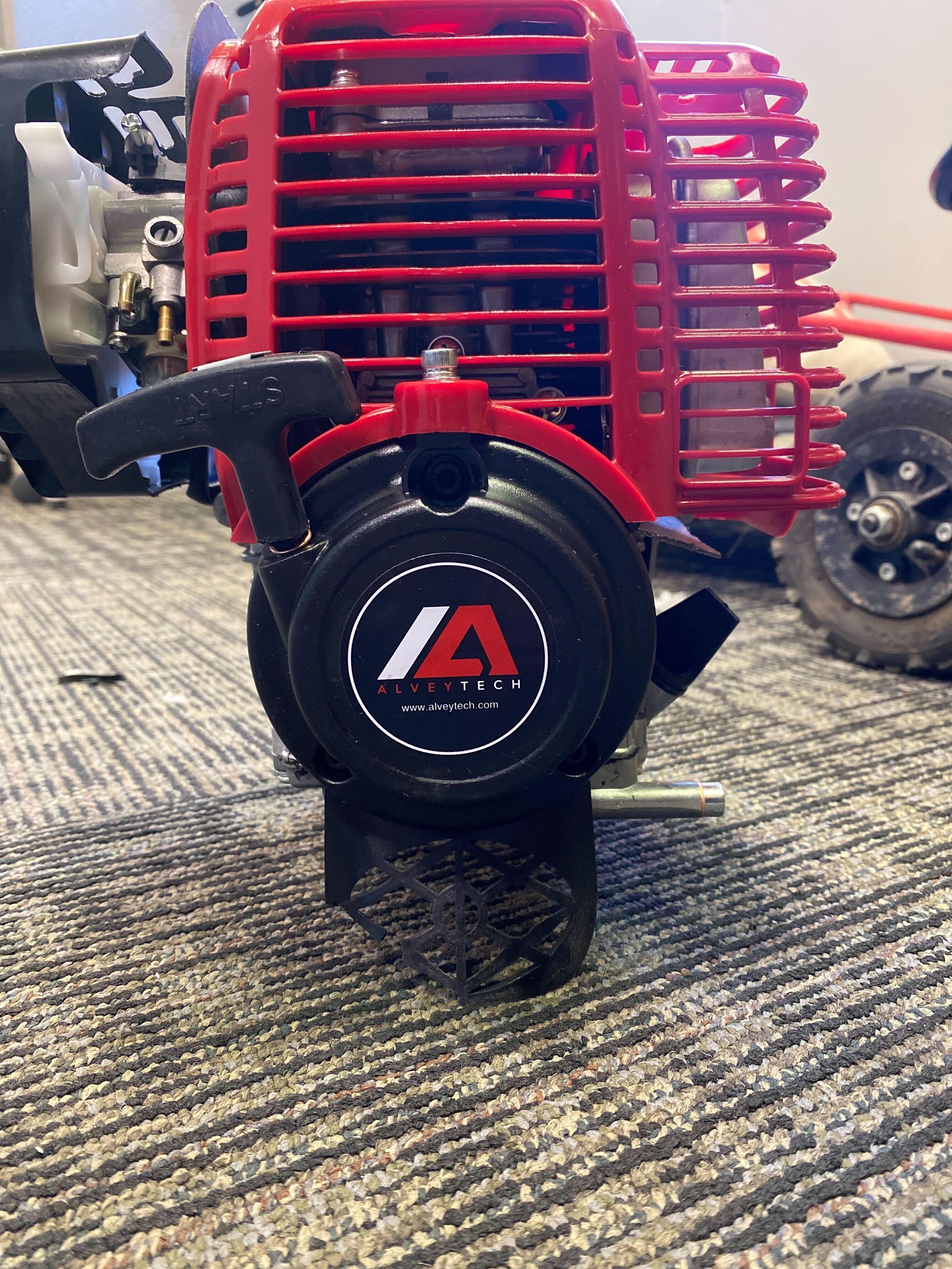 Close-up of the 40cc 4-Stroke Engine for ATVs, Dirt Bikes, & Mini Bikes (Blemished), showcasing its detailed metal components and a prominent wheel mechanism.