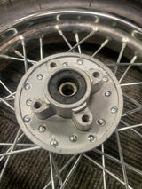 Close-up of the 12 (3.00-12) Rear Rim & Tire Wheel Assembly for Dirt Bikes with Disc Brakes (Version 1) (Blemished), highlighting the metal hub, spokes, and knobby tread pattern.