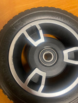 7x2 Solid Front Wheel Assembly for Jazzy Zero Turn & Pride Zero Turn 8 Scooters (Blemished) featuring a black tire with a silver rim, showing minor scratches that do not affect functionality.