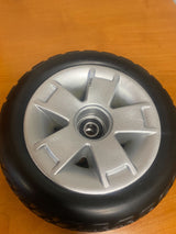 Front Wheel Assembly with Black Molded Tire for Pride Victory 9 4-Wheel Scooter (SC709) (Blemished), featuring a silver rim with minor scrapes and no hub cap, displayed on a flat surface.