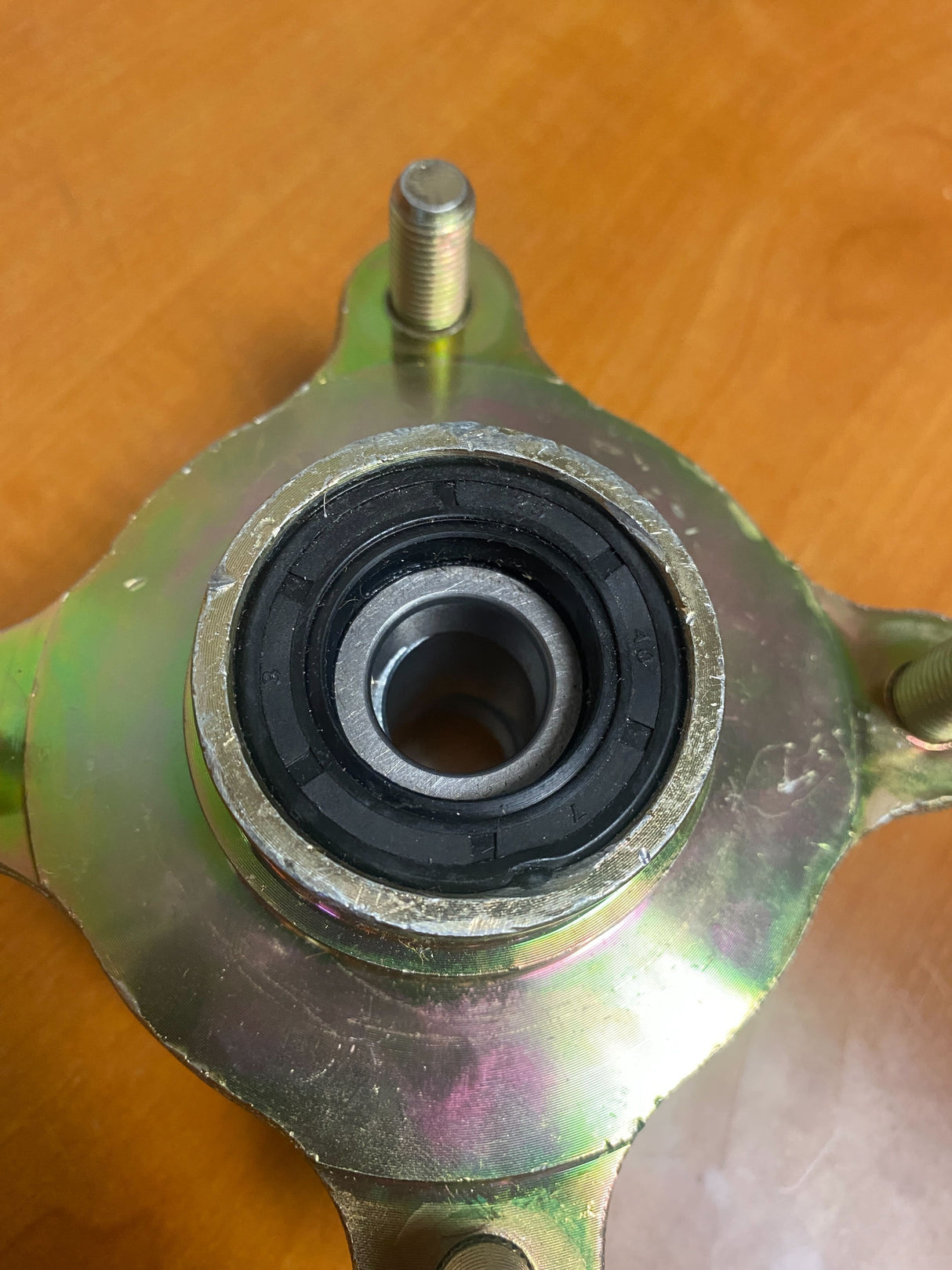 Front Wheel Hub for Hammerhead Off-Road® 150cc Go-Karts (Blemished), featuring a round center with visible screw holes and bolts. Note: Blemishes present on the inner face and bearing cover.