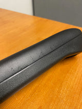 12 Black Vinyl Armrest Pad for the Pride Victory 9 and 10 (Blemished) shown on a wooden surface, highlighting a small defect on the side.