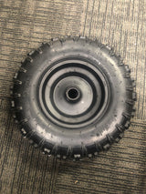 13x5.00-6 Front Tire and Rim Wheel Assembly for Coleman CK100 & SK100 Go-Karts, showing a black wheel on a carpet, highlighting its circular design, steel rim, and integrated bearings.