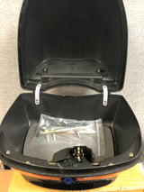 Universal Gloss Black Top Case Scooter Trunk (Blemished) shown open, revealing a plastic bag inside and a metal bar with screws. The case features a glossy black finish and a padded backrest.