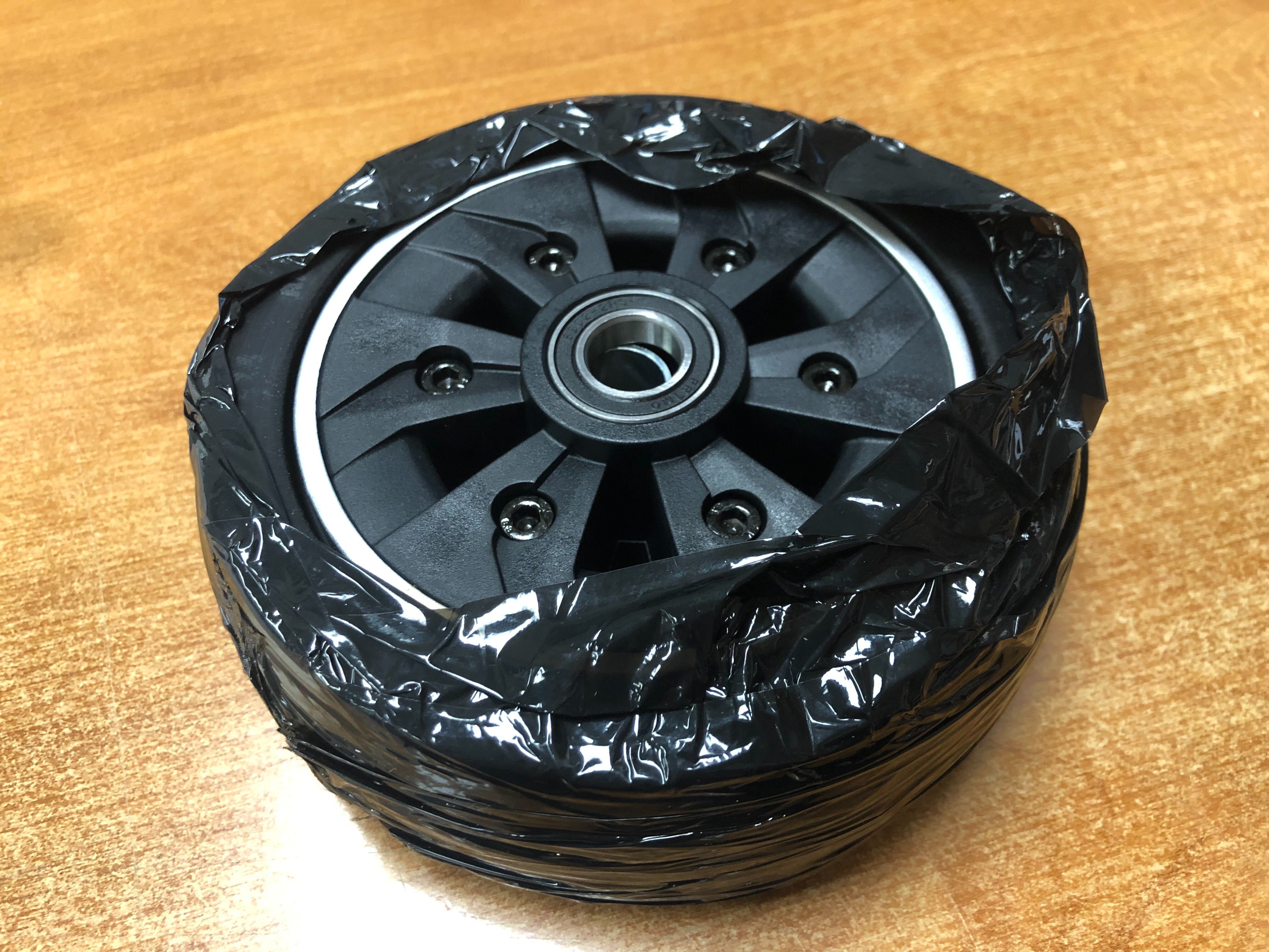 6 Caster Wheel for the Jazzy Air 2 Power Chair, featuring a black tire on a silver rim, partially wrapped in plastic.