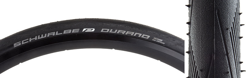 20x1.1 Durano Perf Lite RG Bicycle Tire: Close-up of a black bicycle tire featuring white text, showcasing dual compound tread and RaceGuard puncture protection with thin, light sidewalls for reduced rolling resistance.