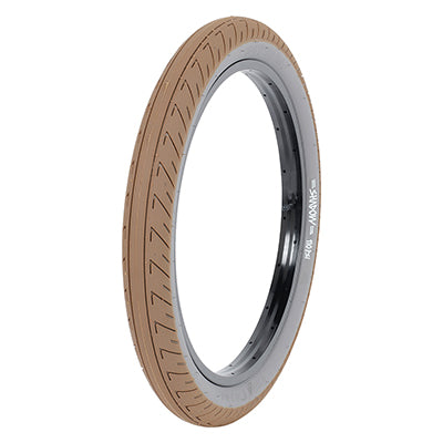 20x2.3 Cream Strada Nuova Bicycle Tire featuring a black rim and a smooth centerline with siped shoulders, designed for durability and flat resistance. Signature tire by Simone Barraco.