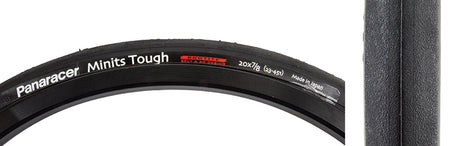 Close-up of 20x7/8 Minits Tough Bicycle Tire, highlighting its lightweight, fast-rolling design ideal for commuting or touring, with visible white text on the black tire.