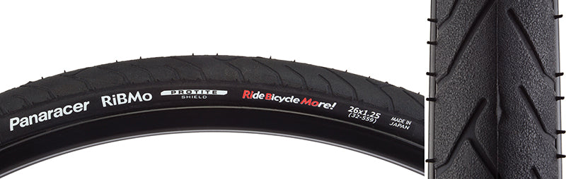 Close-up of the 26x1.25 Ribmo Wire Bicycle Tire, showcasing its all-contact tread pattern and durable compound. Features Panaracer's Protite puncture protection technology.