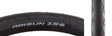 Close-up of the 26x1.5 ZRS Wire/30 Bicycle Tire, showcasing its smooth, fast-rolling center and grooved shoulders designed for enhanced cornering traction.