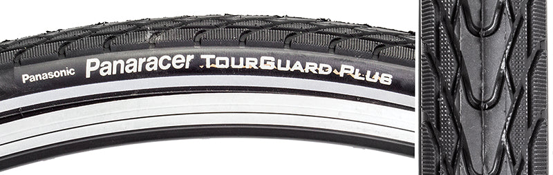 Close-up of the 26x1.75 Reflective Tourguard Plus Bicycle Tire, showcasing its deep tread pattern and puncture-resistant rubber belt designed for urban use.