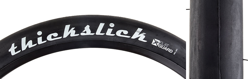 26x2.0 ThickSlick Flat Guard Bicycle Tire with white text on the sidewall, featuring extra thick slick tread designed for puncture resistance and durability, ideal for fixie riders.