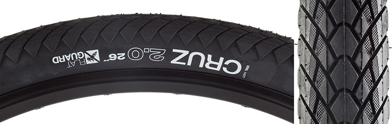 26x2.0 Cruz Flat Guard Bicycle Tire close-up showing shallow, tightly spaced tread blocks and white text, highlighting its all-weather tread pattern and Flat Guard protection for increased puncture resistance and durability.