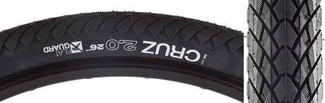 26x2.0 Cruz Flat Guard Bicycle Tire close-up showing shallow, tightly spaced tread blocks and white text, highlighting its all-weather tread pattern and Flat Guard protection for increased puncture resistance and durability.