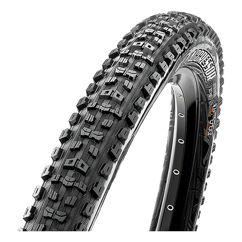 Close-up of 26x2.3 Aggressor DC/EXO/TR Bicycle Tire showcasing aggressive center tread, large corner lugs, and durable sidewalls designed for wet/loose conditions.