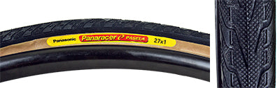 27x1 Black/Black Pasela Bicycle Tire, featuring a yellow label and raised center tread for low rolling resistance. Close-up shows durable synthetic rubber and detailed tread pattern.