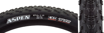 Close-up of a 27.5x2.25 Aspen DC/EXO/TR Bicycle Tire showcasing its fast-rolling center tread and aggressive shoulder knobs, highlighting the dual compound rubber and EXO sidewall protection.