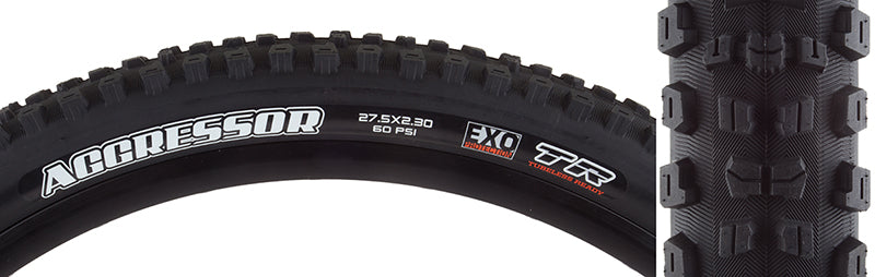 Close-up of a 27.5x2.3 Aggressor DC/EXO/TR Bicycle Tire showcasing its aggressive center tread and large corner lugs, designed for wet/loose conditions with EXO sidewall protection and tubeless readiness.