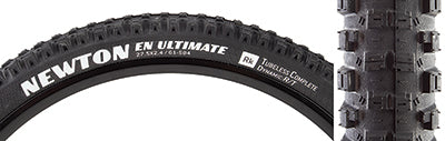 27.5x2.4 Newton Ultimate Bicycle Tire featuring close-up of the black tire with white text, highlighting its fast-rolling tread and side knobs for superior traction and durability.