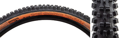 Close-up view of the 27.5x2.4 Black/Tan Trail Boss TCS Light Fast Rolling Bicycle Tire, showcasing its tread pattern designed for high-speed performance and enhanced braking with durable, multi-compound rubber for trail riding.