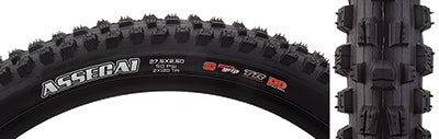 Close-up of the 27.5x2.5 Assegai 3CG/DD/TR/WT Bicycle Tire, highlighting its alternating vertical knobs, deep siping, and large corner knobs designed for enhanced traction and downhill performance.