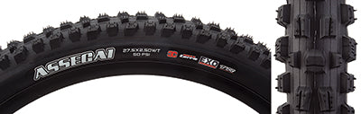 Close-up of the 27.5x2.5 Assegai EXO/TR/WT Bicycle Tire, highlighting its alternating vertical knobs, deep siping, and large corner knobs designed for improved traction and performance.