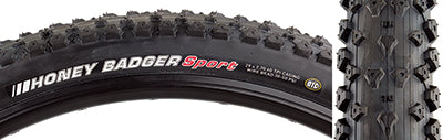 Close-up of a 29x2.2 Honey Badger Sport Bicycle Tire showcasing its triangular knobs and tread pattern designed for optimal grip on hard pack and loose loamy conditions.