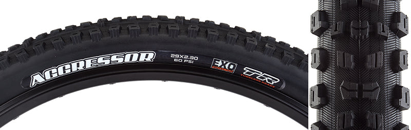 Close-up of the 29x2.3 Aggressor DC/EXO/TR Bicycle Tire, showcasing aggressive center tread and large corner lugs, designed for wet/loose conditions with EXO sidewall protection and dual compound tread.