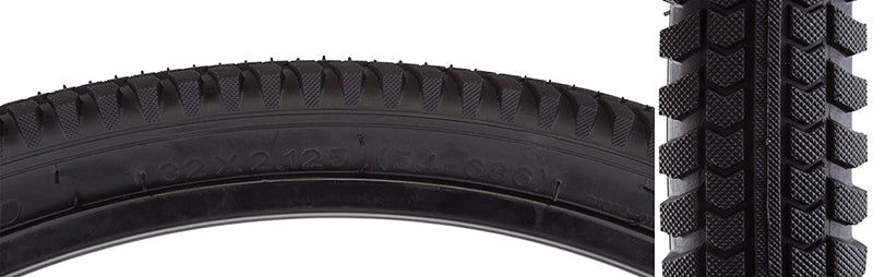 32x2.125 Cruiser Directional Bicycle Tire close-up, highlighting smooth rolling center pattern with larger lugs on shoulders for corner traction and square profile, ideal for sandy boardwalks or gravel trails.