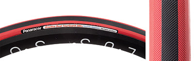 Close-up of the 700x22 Black/Red Practice Dual Bicycle Tire, featuring a puncture-resistant aramid belting and a removable 42mm valve, designed for training.