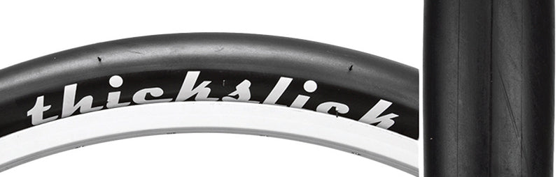 Close-up of the 700x23 ThickSlick Comp Bicycle Tire showing its extra thick slick tread designed for puncture resistance and long wear life, ideal for fixie riders.