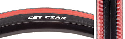 Close-up of a 700x23 Black/Red Czar Bicycle Tire with grooved lateral tread and smooth center, highlighting the tire's dual compound and exceptional puncture safety features.