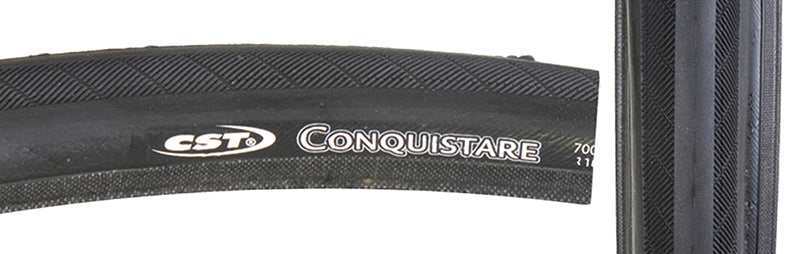 Close-up of the 700x23 Conquistare Bicycle Tire showcasing its slick center for low rolling resistance and filed-pattern edges for enhanced cornering, with visible branding and durable, anti-puncture design.